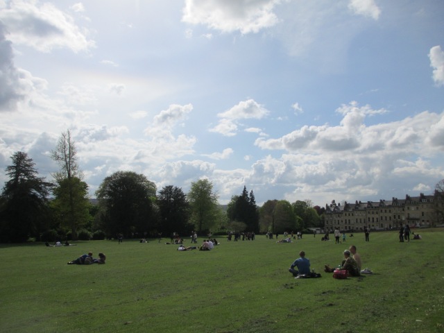 people relaxing on the lawn outside the Royal Crescent